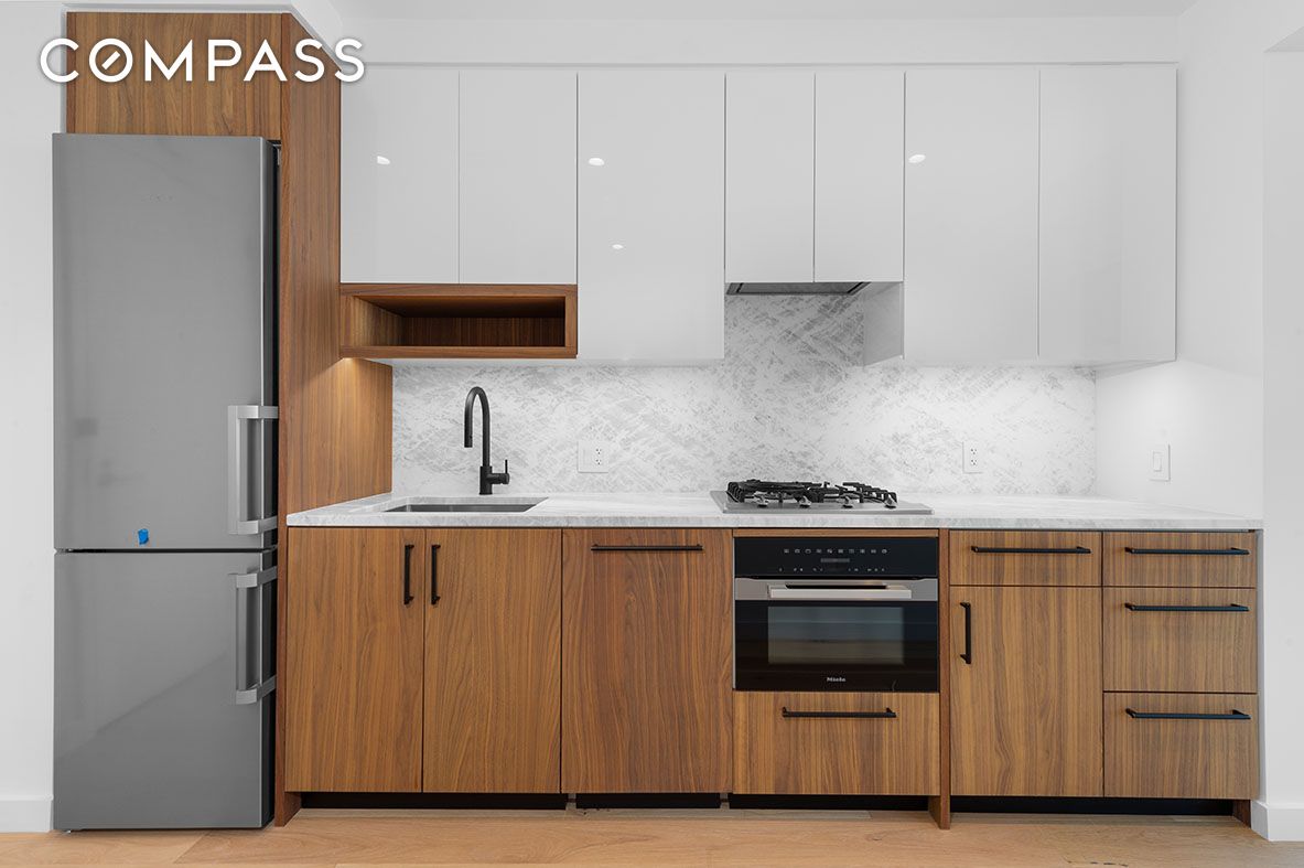 29 Huron Street, Unit 10AW Brooklyn, NY 11222 - Photo 7 of 13 a kitchen with stainless steel appliances a stove and a refrigerator