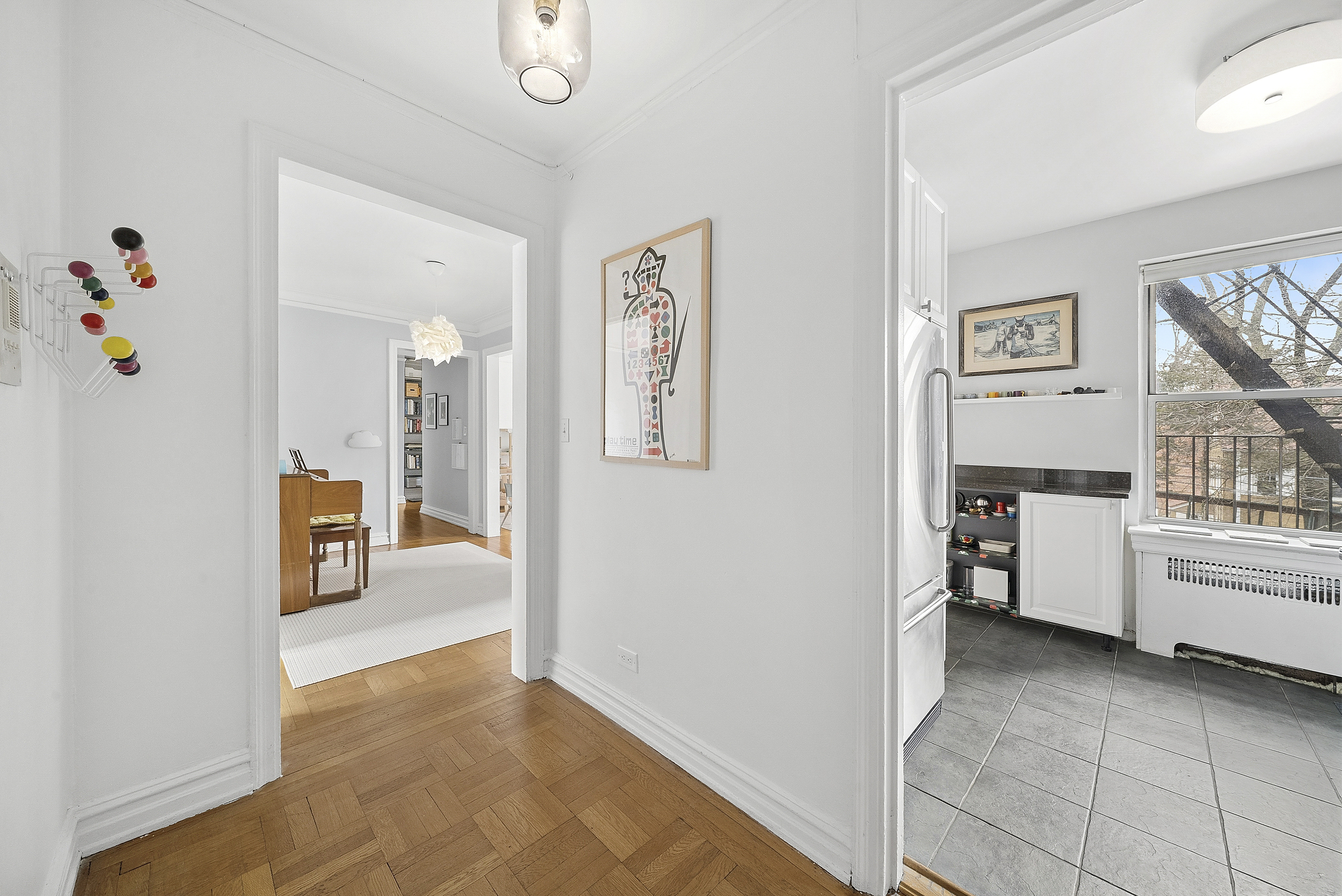 474 West 238th Street, Unit 2E Bronx, NY 10463 - Photo 10 of 13 a view of a hallway that has a dining table and chairs