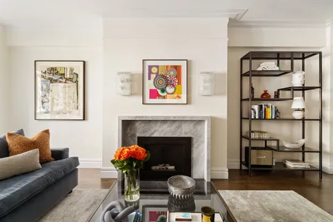 a living room with furniture a rug and a fireplace
