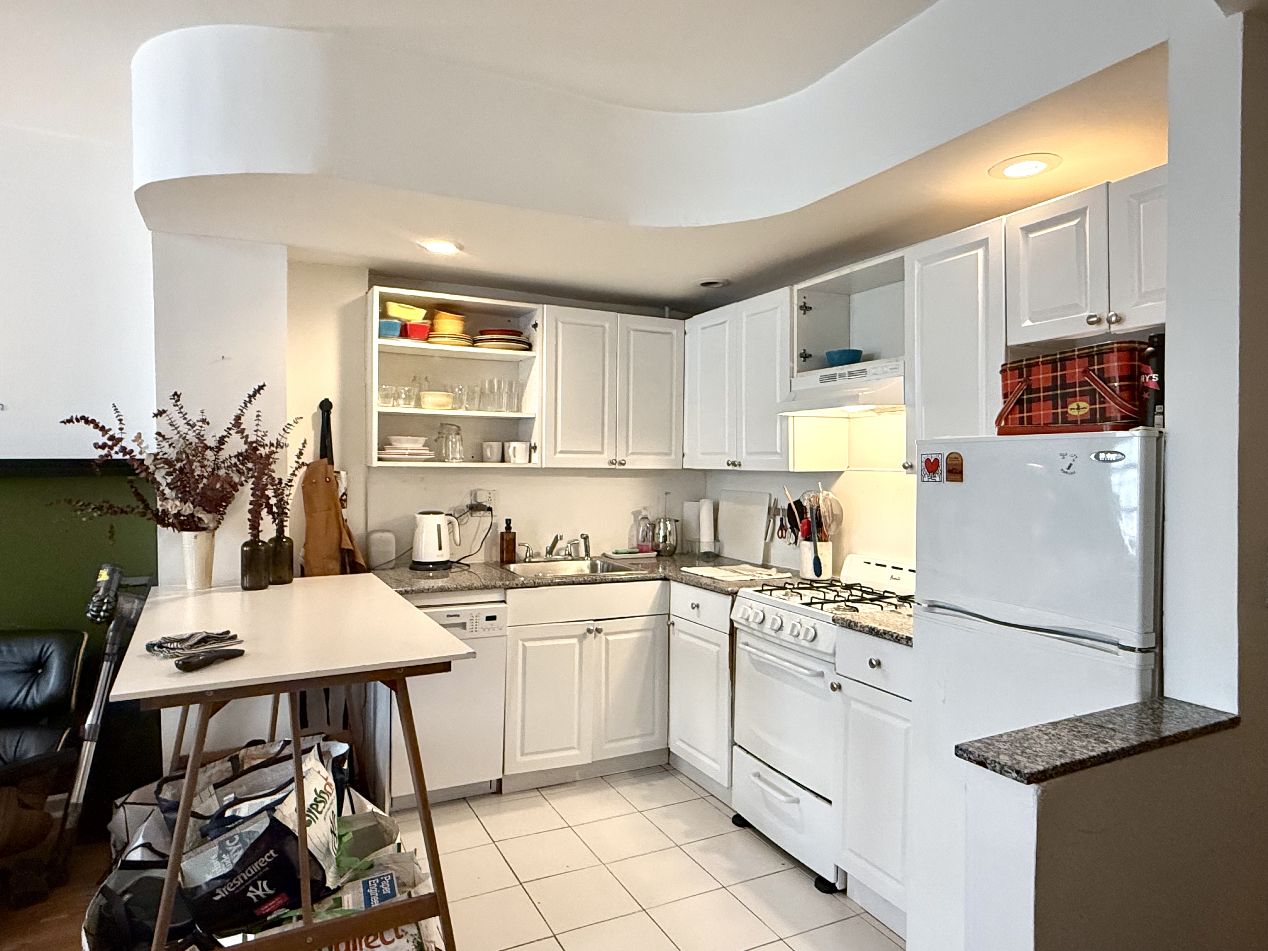 Address Upon Request Manhattan, NY 10029 - Photo 5 of 11 a kitchen with a white table chairs and refrigerator