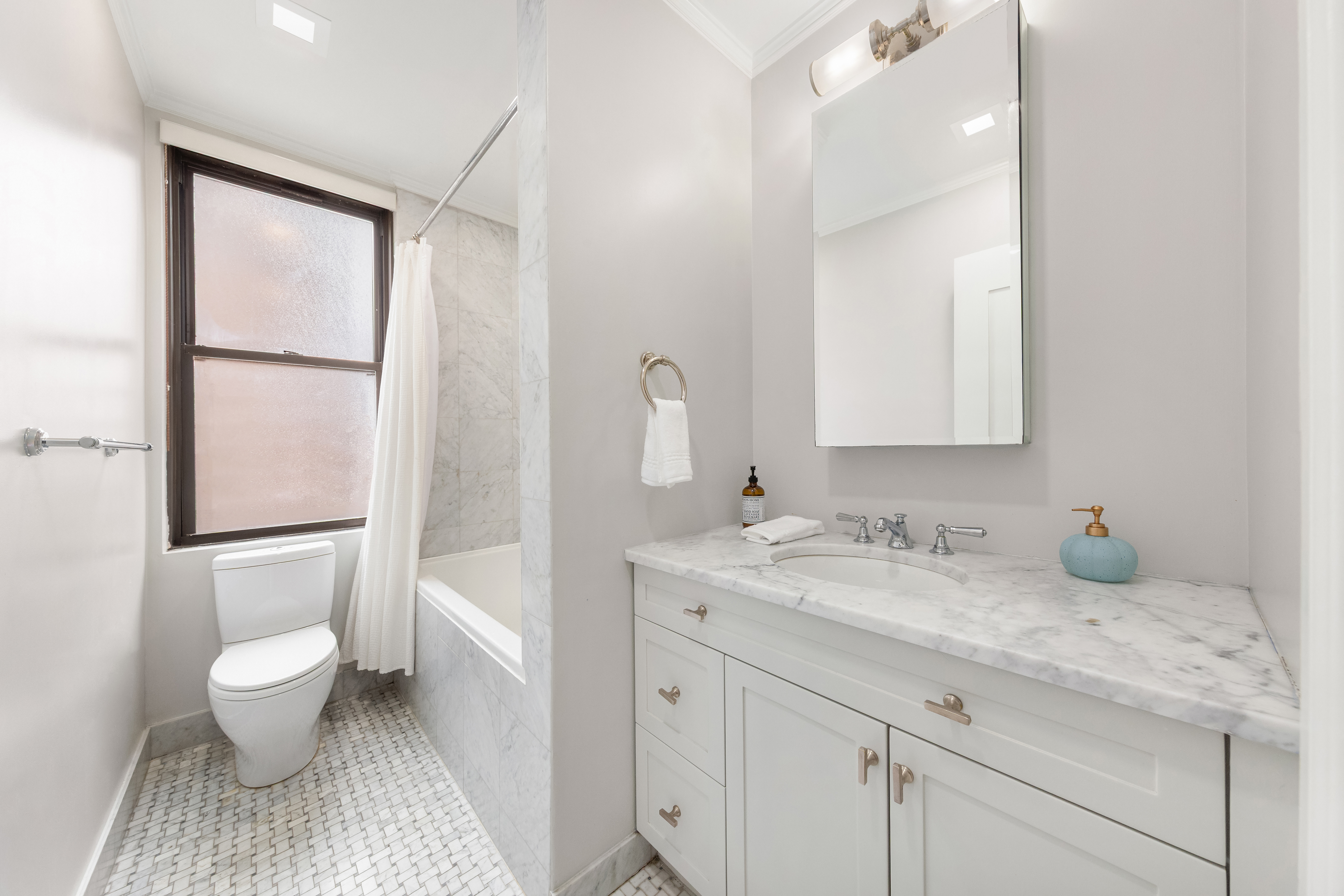 905 West End Avenue, Unit 81 Manhattan, NY 10025 - Photo 11 of 14 a spacious bathroom with a granite countertop sink toilet and mirror