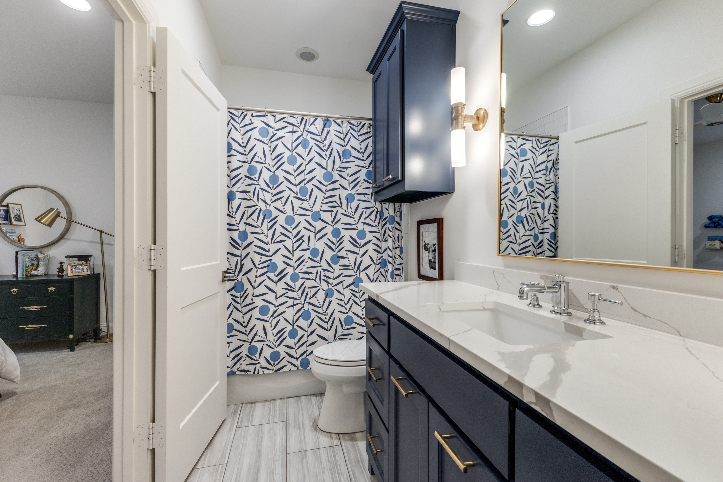 4042 Dunhaven Road Dallas, TX 75220 - Photo 25 of 34 a bathroom with a sink and a mirror