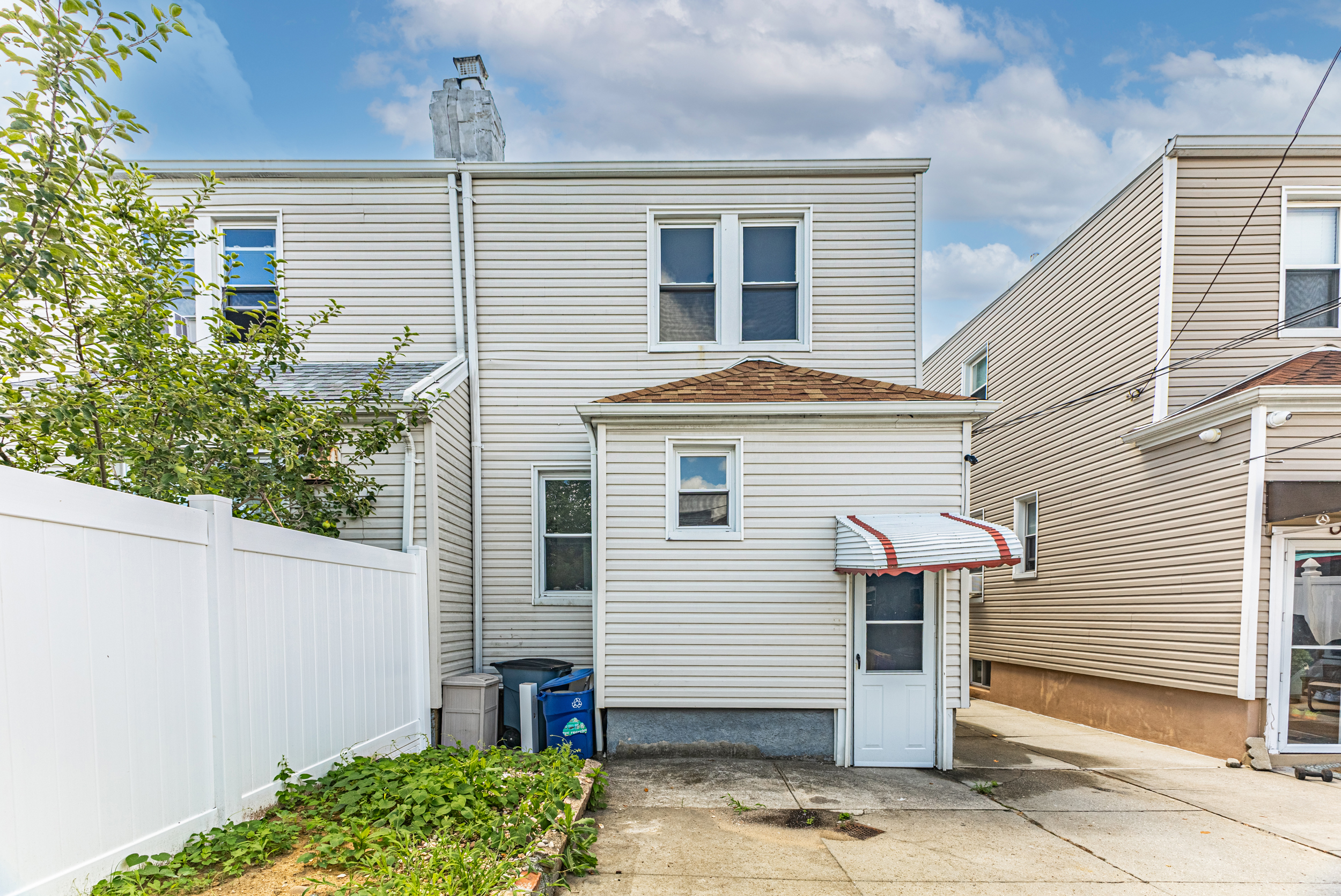 69-29 67th Place Queens, NY 11385 - Photo 20 of 24 a front view of a house with garden