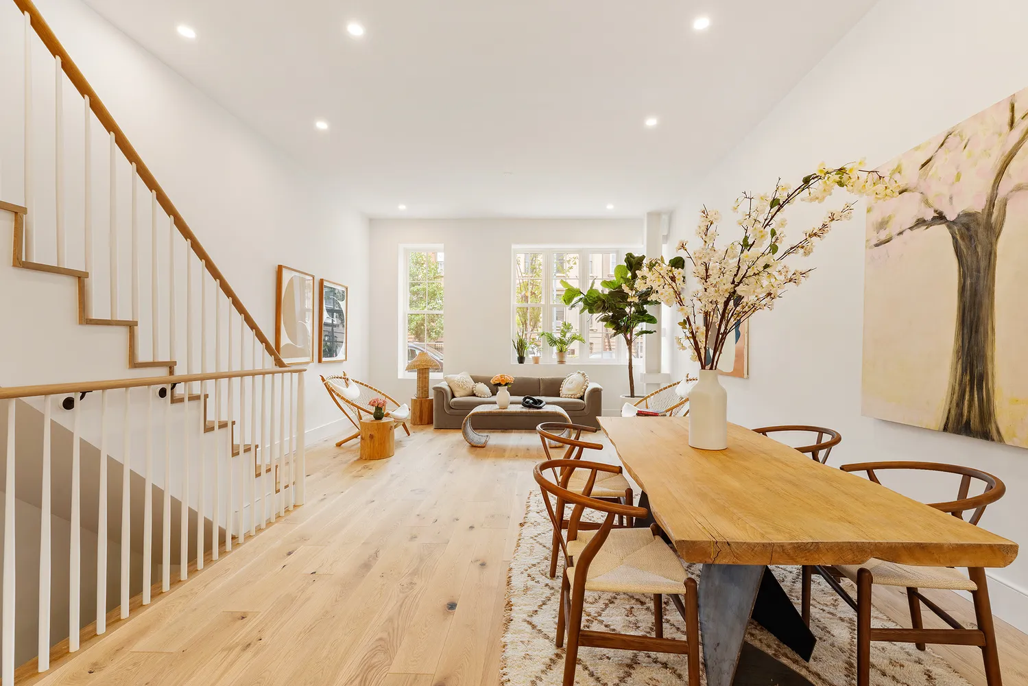 a view of a dining room with furniture and a potted plant