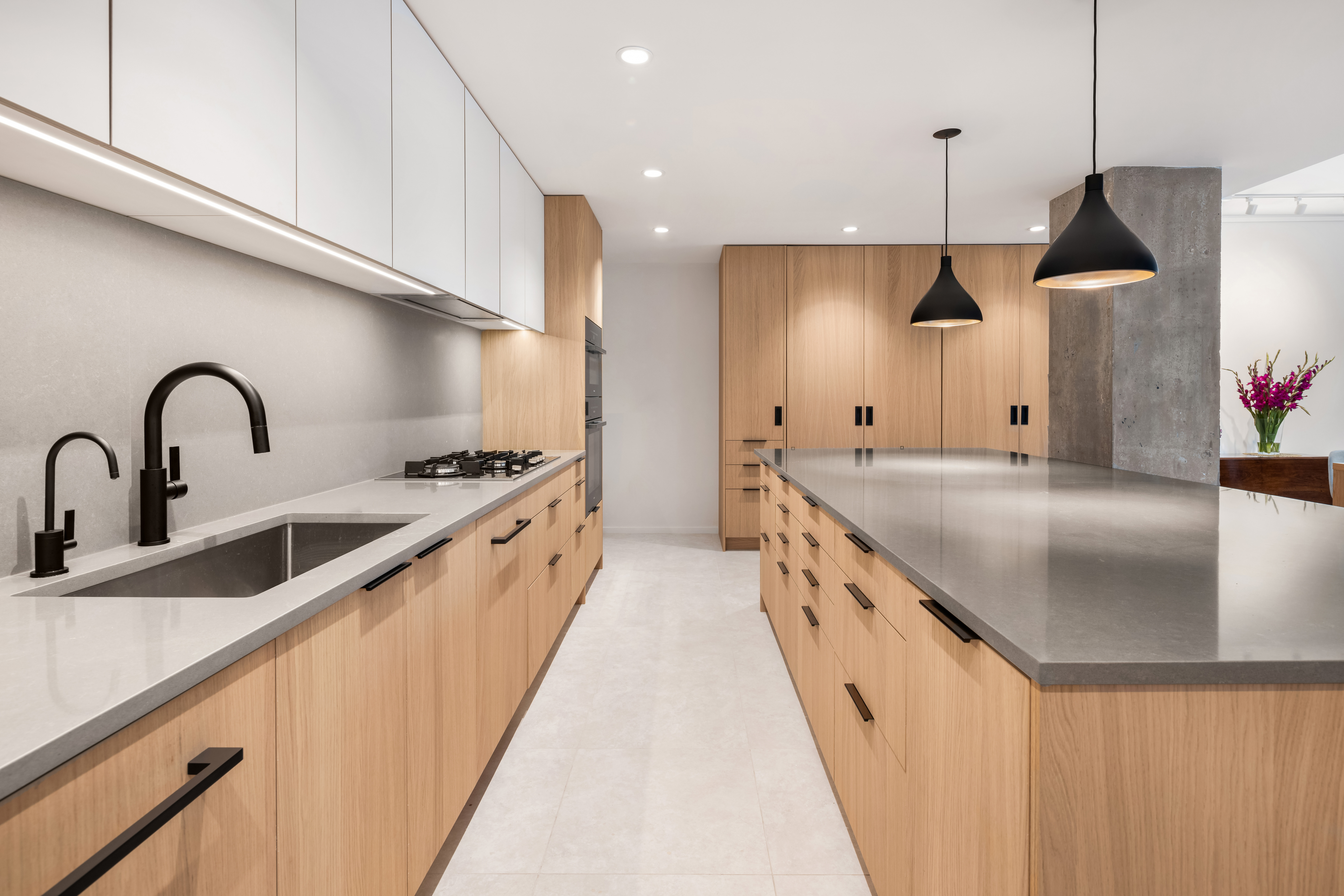 404 East 76th Street, Unit 2B Manhattan, NY 10021 - Photo 3 of 24 a large kitchen with stainless steel appliances kitchen island a large kitchen island a stove a sink a refrigerator and a wooden floors