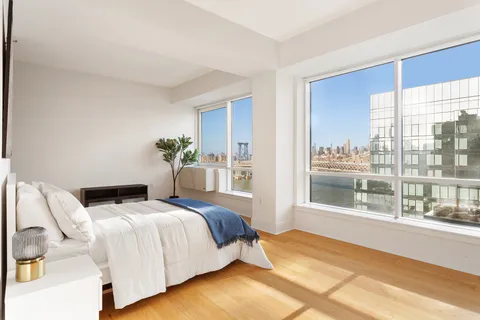 a bedroom with a large bed and a large window