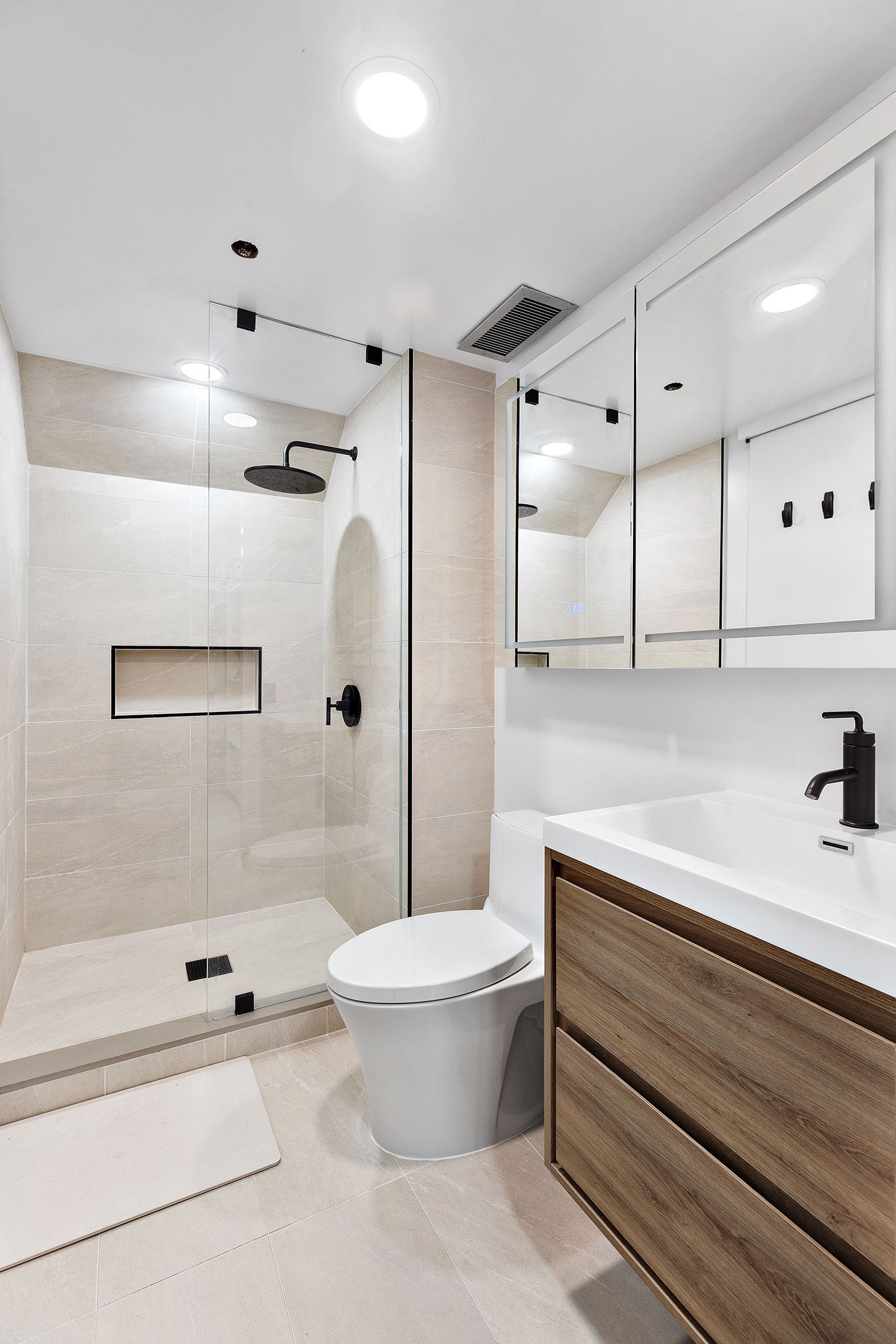 155 West 15th Street, Unit 1J Manhattan, NY 10011 - Photo 9 of 13 a bathroom with a sink a toilet and shower