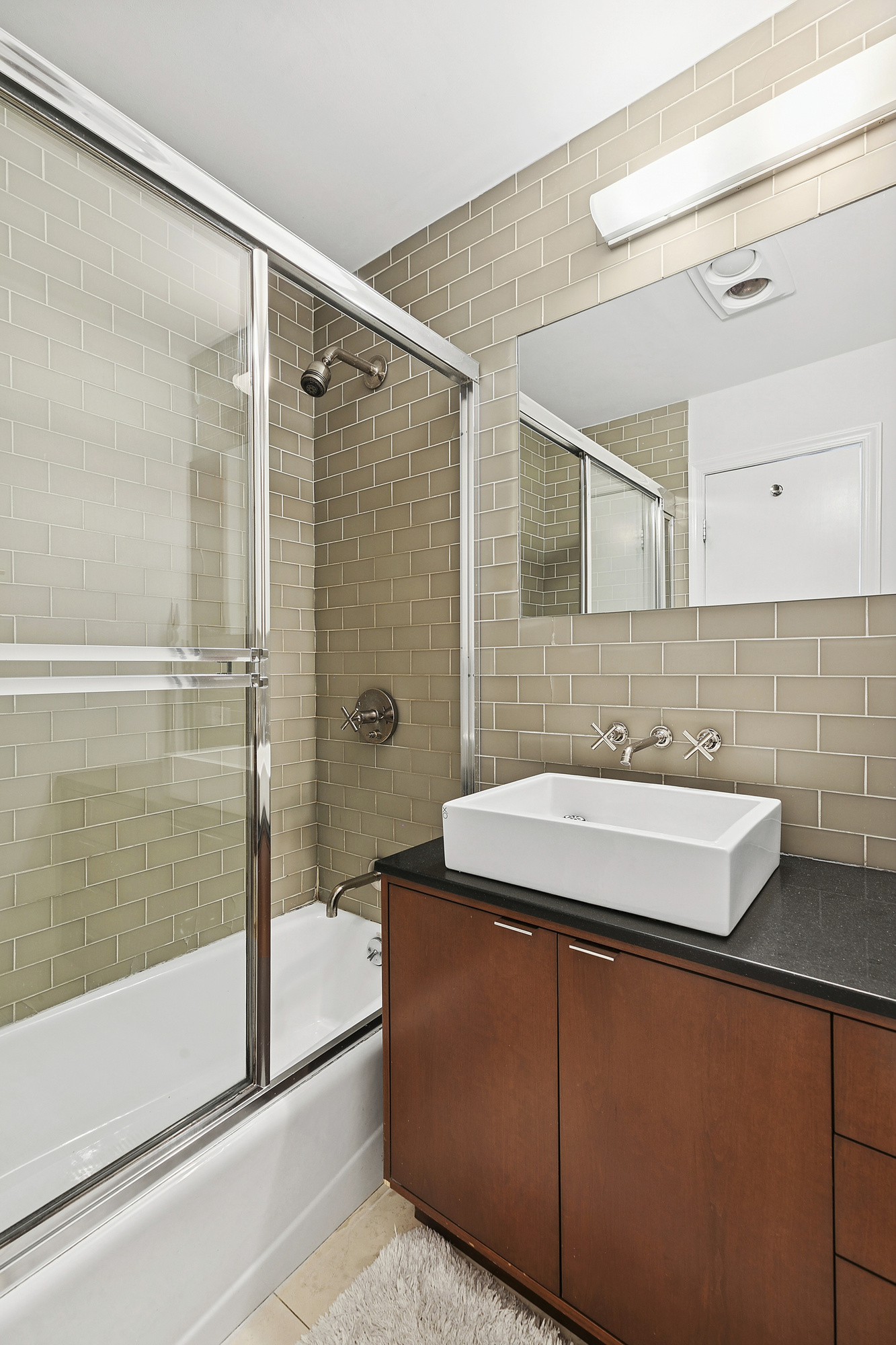 220 East 5th Street, Unit PHE Manhattan, NY 10003 - Photo 10 of 11 a bathroom with a sink and mirror with bathtub