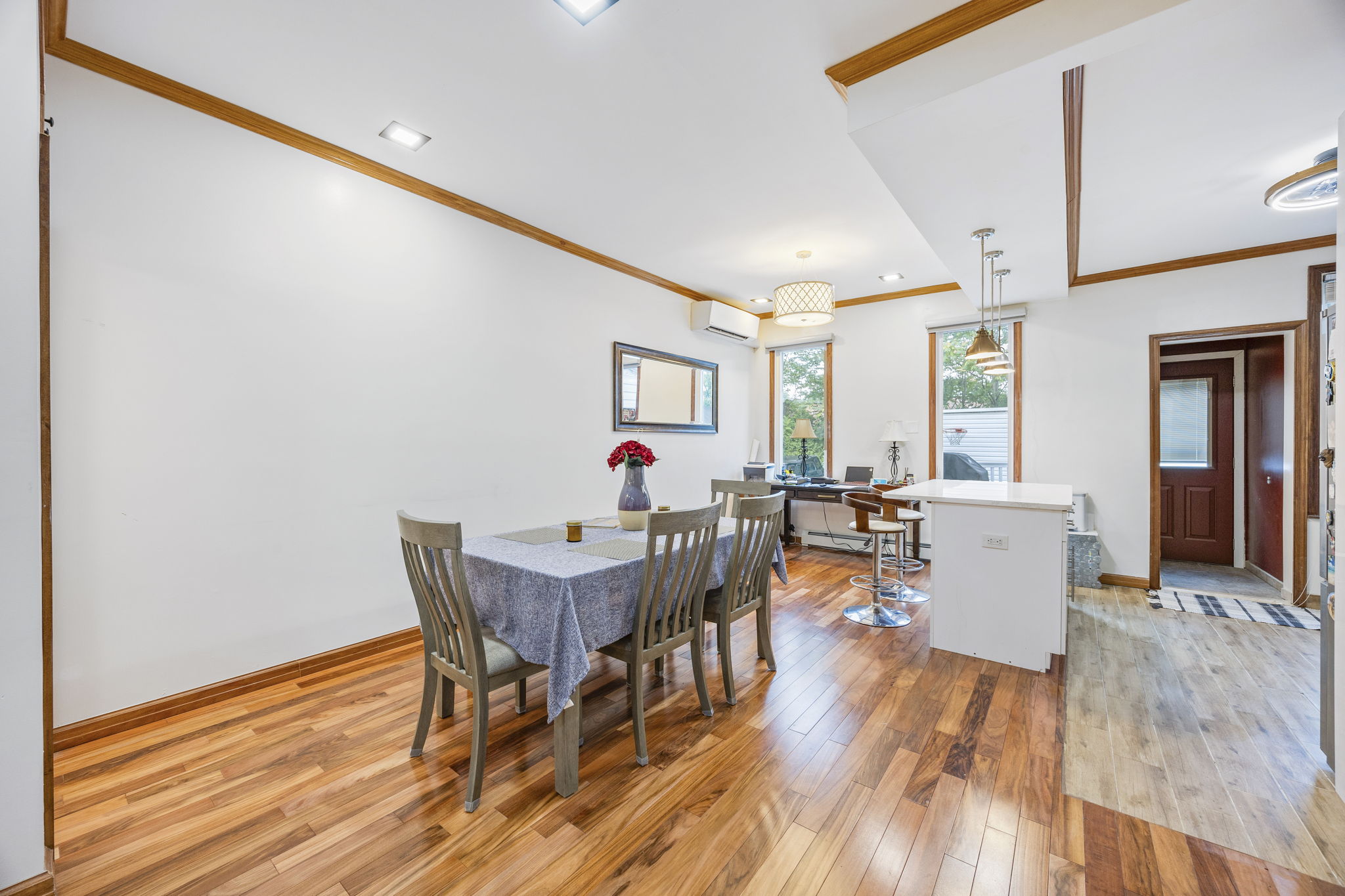 25-69 46th Street Queens, NY 11103 - Photo 19 of 33 a view of a dining room with furniture and wooden floor