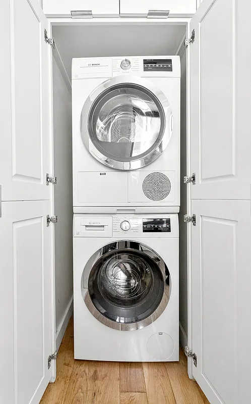 342 West 21st Street, Unit 4B Manhattan, NY 10011 - Photo 5 of 9 a utility room with dryer and washer