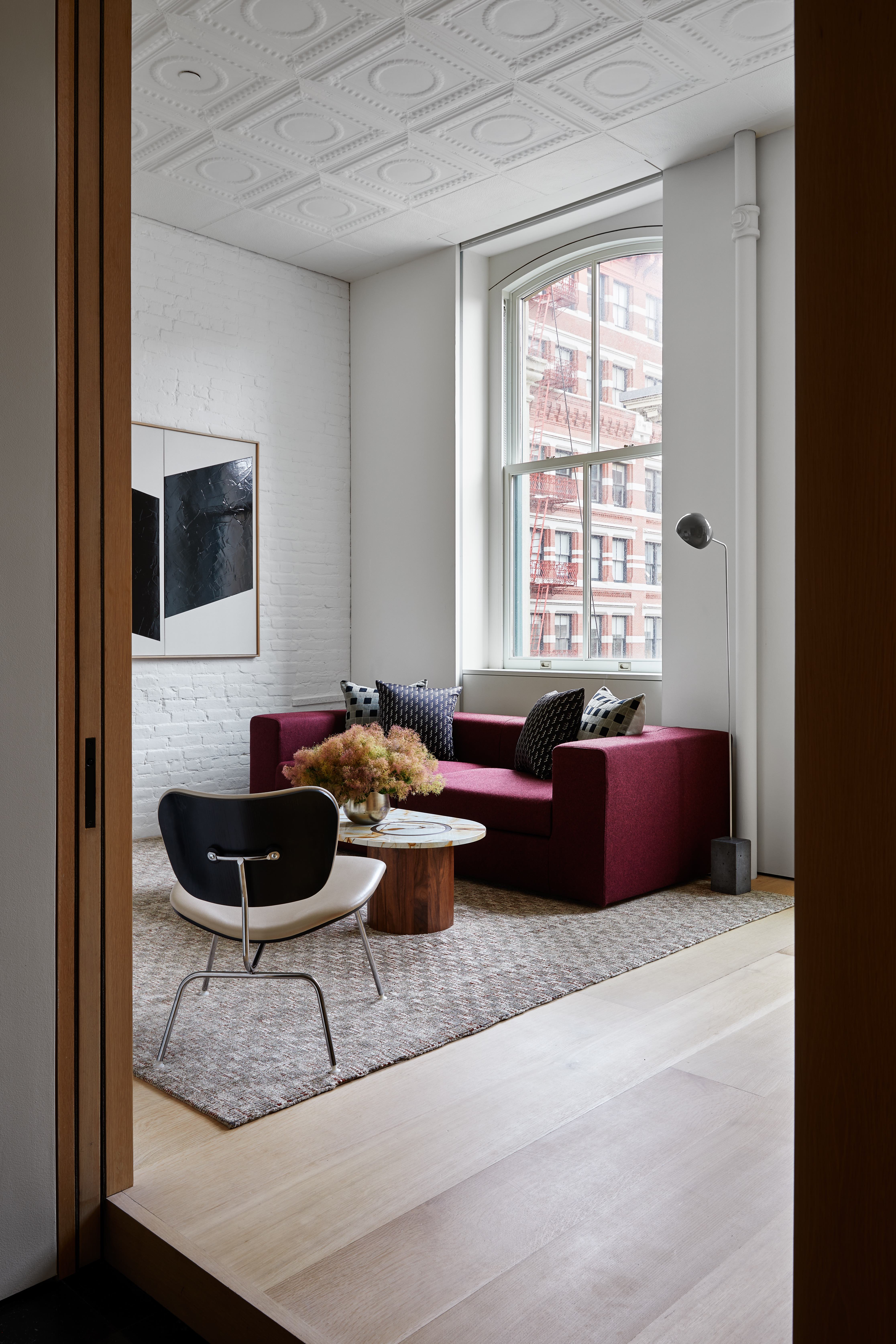 100 Grand Street, Unit 4 Manhattan, NY 10013 - Photo 9 of 13 a living room with furniture a flat screen tv and a window