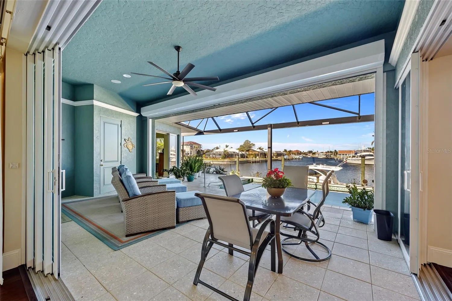 a dining room with furniture water view and a floor to ceiling window
