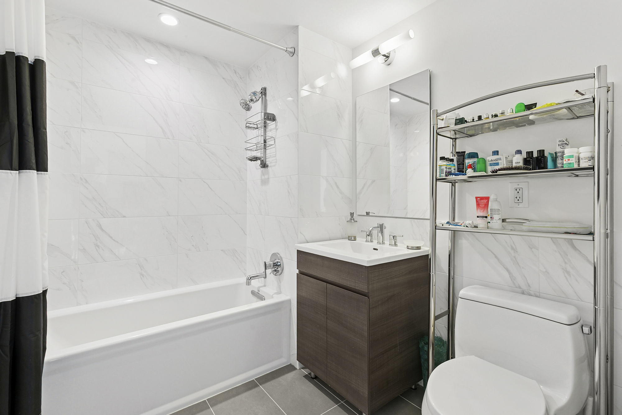 2351 Adam Clayton Powell Jr Boulevard, Unit PH23 Manhattan, NY 10030 - Photo 8 of 9 a bathroom with a sink a toilet and shower