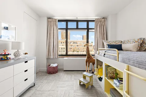 a bedroom with furniture and a window