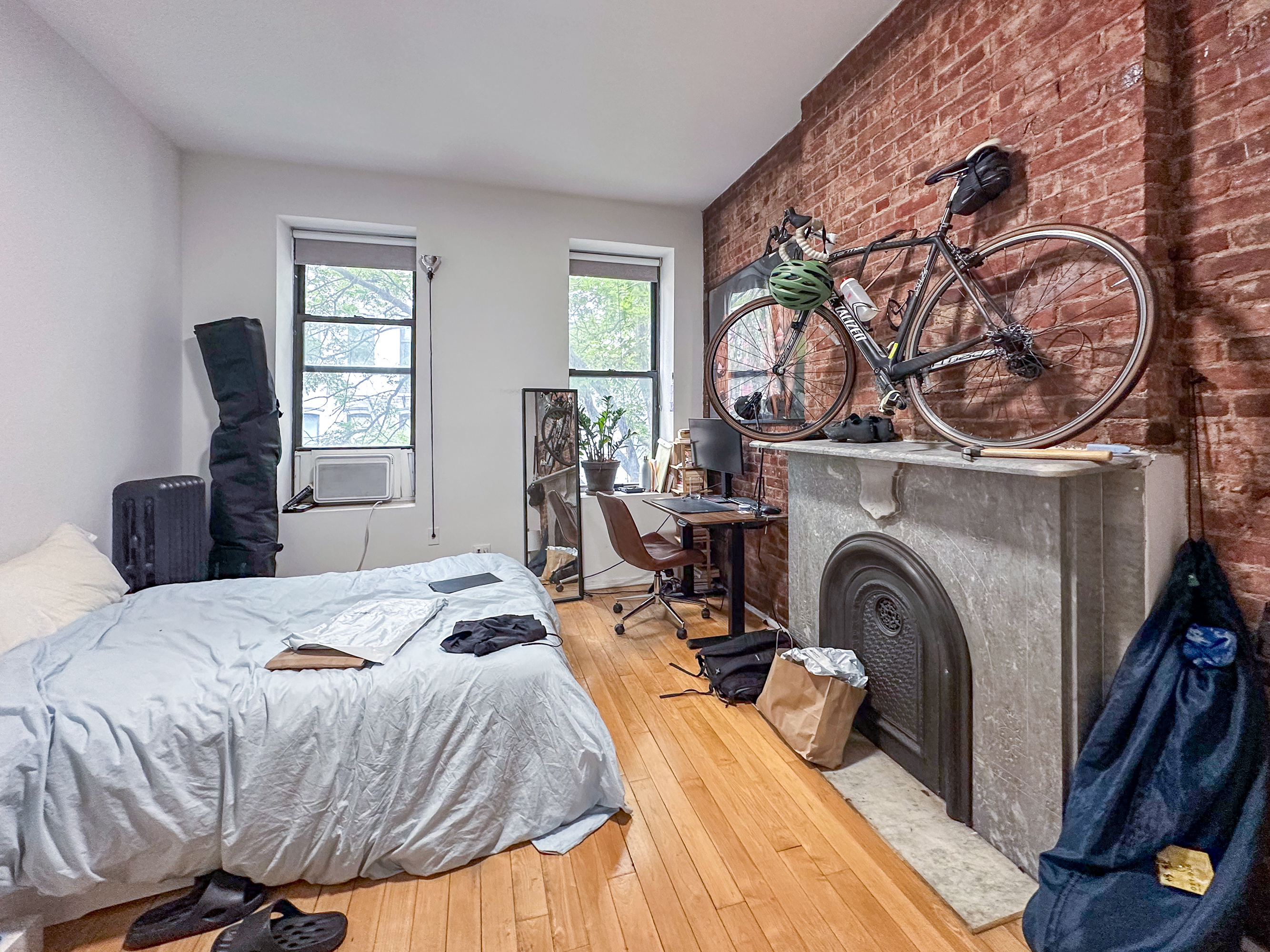 213 East 5th Street, Unit 5 Manhattan, NY 10003 - Photo 3 of 17 a bedroom with a bed and a tv on the dresser