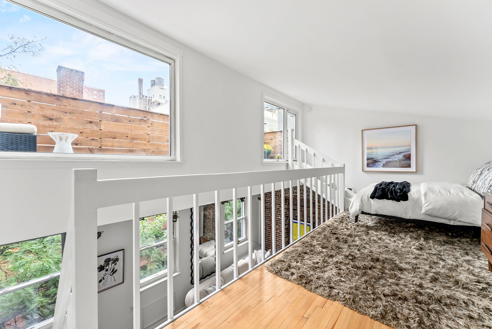 207 East 21st Street, Unit 6E Manhattan, NY 10010 - Photo 7 of 12 a bedroom with furniture and a window