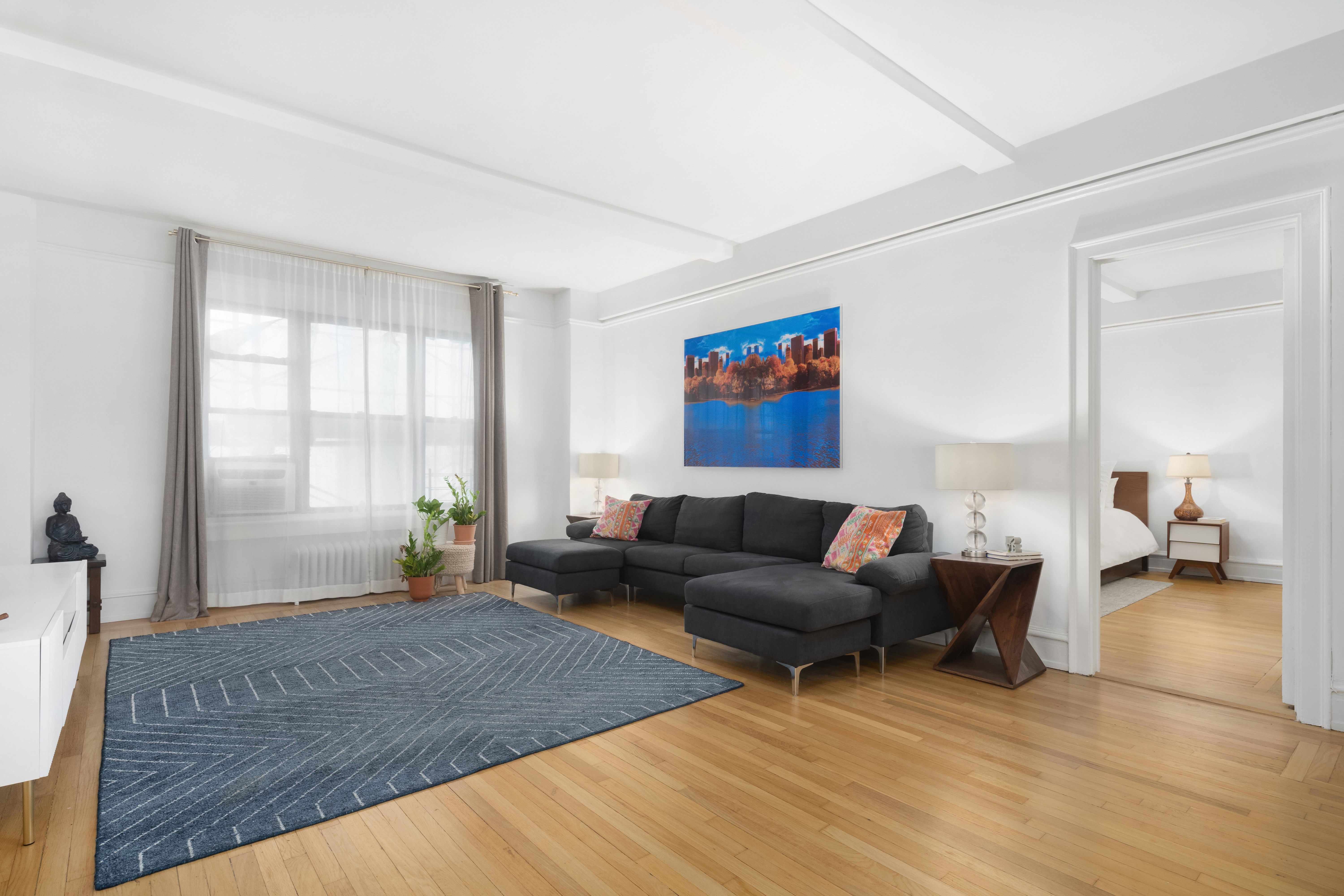150 West 55th Street, Unit 5D Manhattan, NY 10019 - Photo 5 of 12 a living room with furniture and a large window
