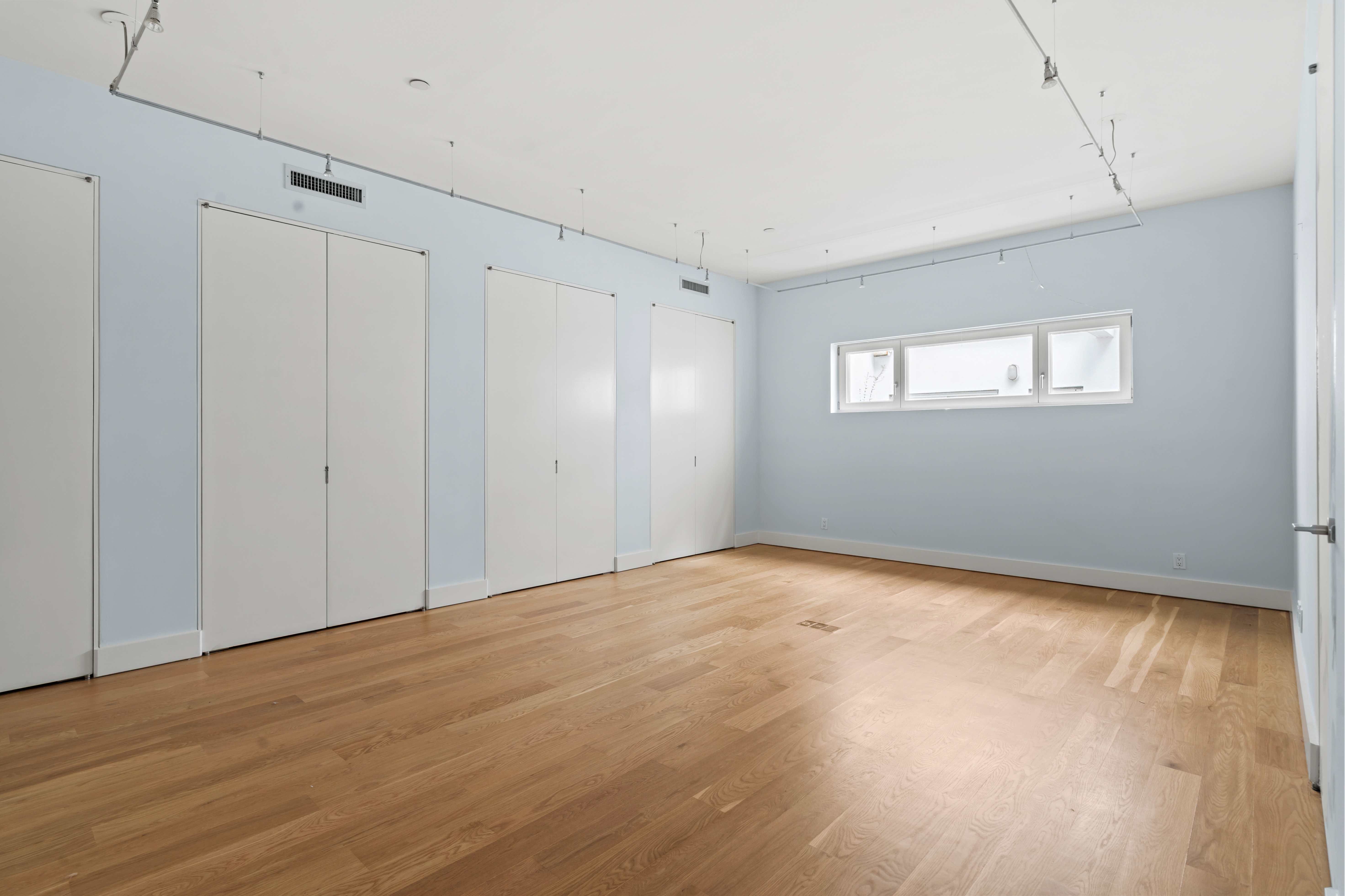 32 Laight Street, Unit 5 Manhattan, NY 10013 - Photo 19 of 31 a view of an empty room with wooden floor and a window