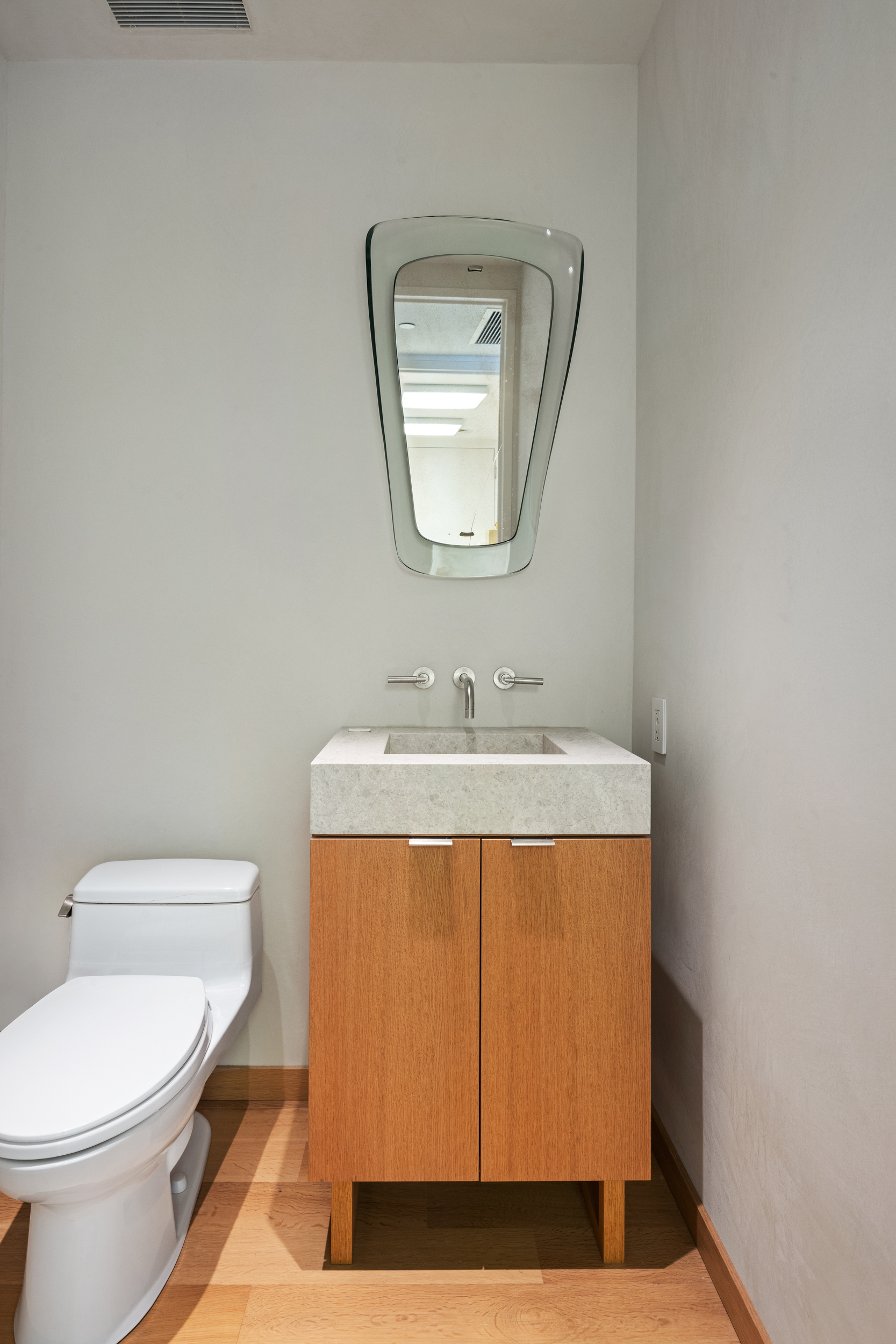 350 West Broadway, Unit 7 Manhattan, NY 10013 - Photo 15 of 17 a bathroom with a sink a toilet and mirror