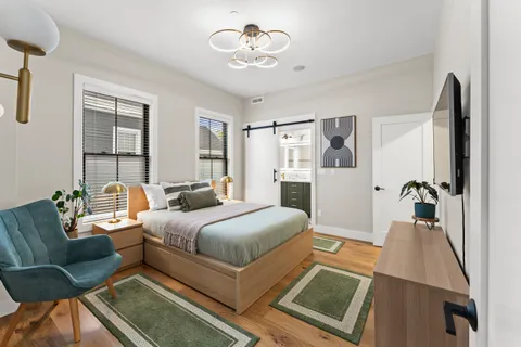 a living room with a bed furniture and a window