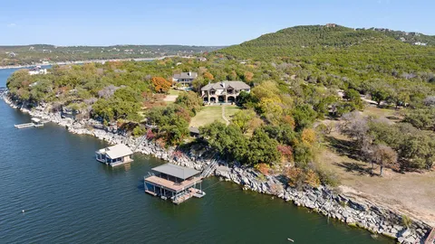 a living room with furniture a fireplace and a chandelier
