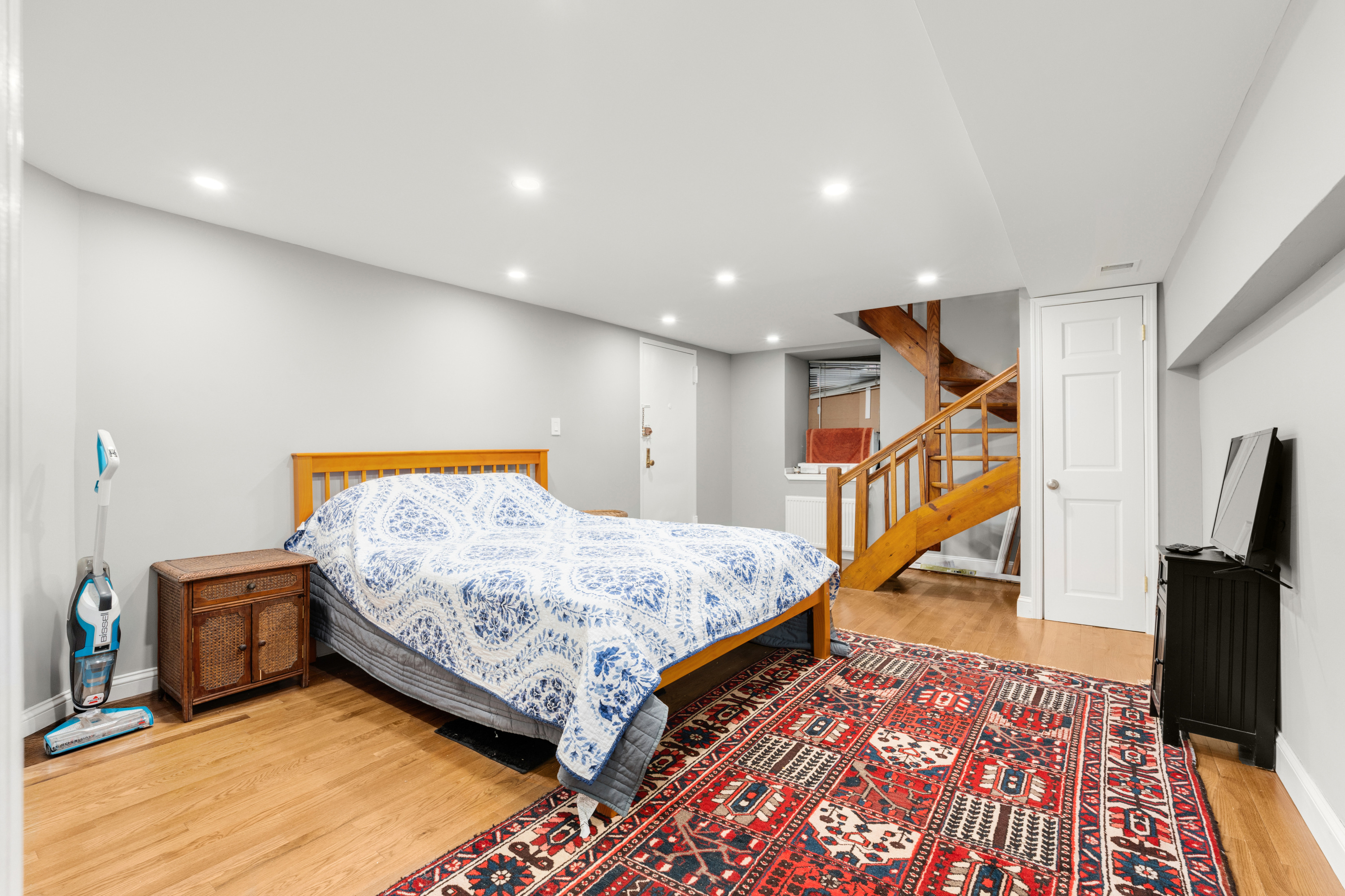 252 West 102nd Street, Unit 1 Manhattan, NY 10025 - Photo 7 of 11 a bed room with a bed and a book shelf