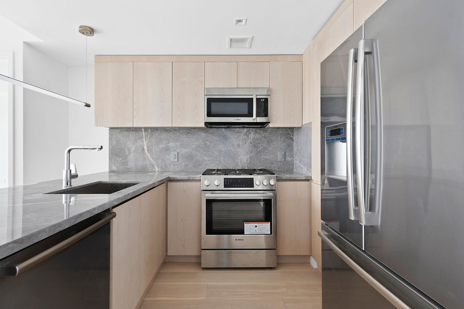 567 Ocean Avenue, Unit B504 Brooklyn, NY 11226 - Photo 3 of 8 a kitchen with stainless steel appliances granite countertop a sink and a stove