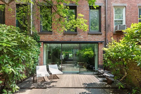 a view of backyard with plants and outdoor seating