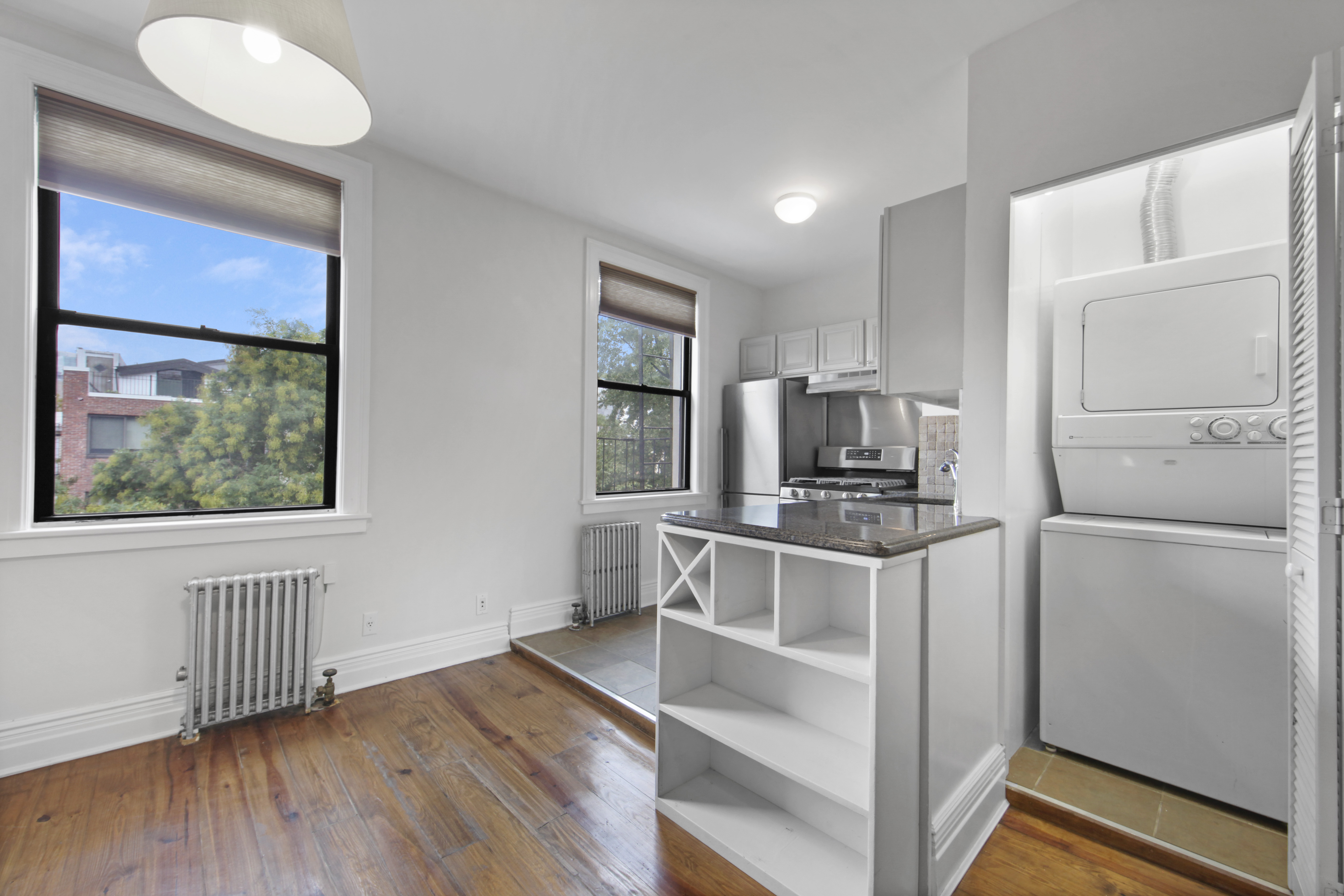 43 Douglass Street, Unit 3 Brooklyn, NY 11231 - Photo 3 of 12 a kitchen with a refrigerator stove and wooden floor