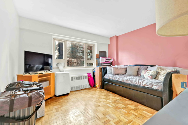 135 Ashland Place, Unit 5A Brooklyn, NY 11201 - Photo 8 of 12 a living room with furniture a flat screen tv and a floor to ceiling window
