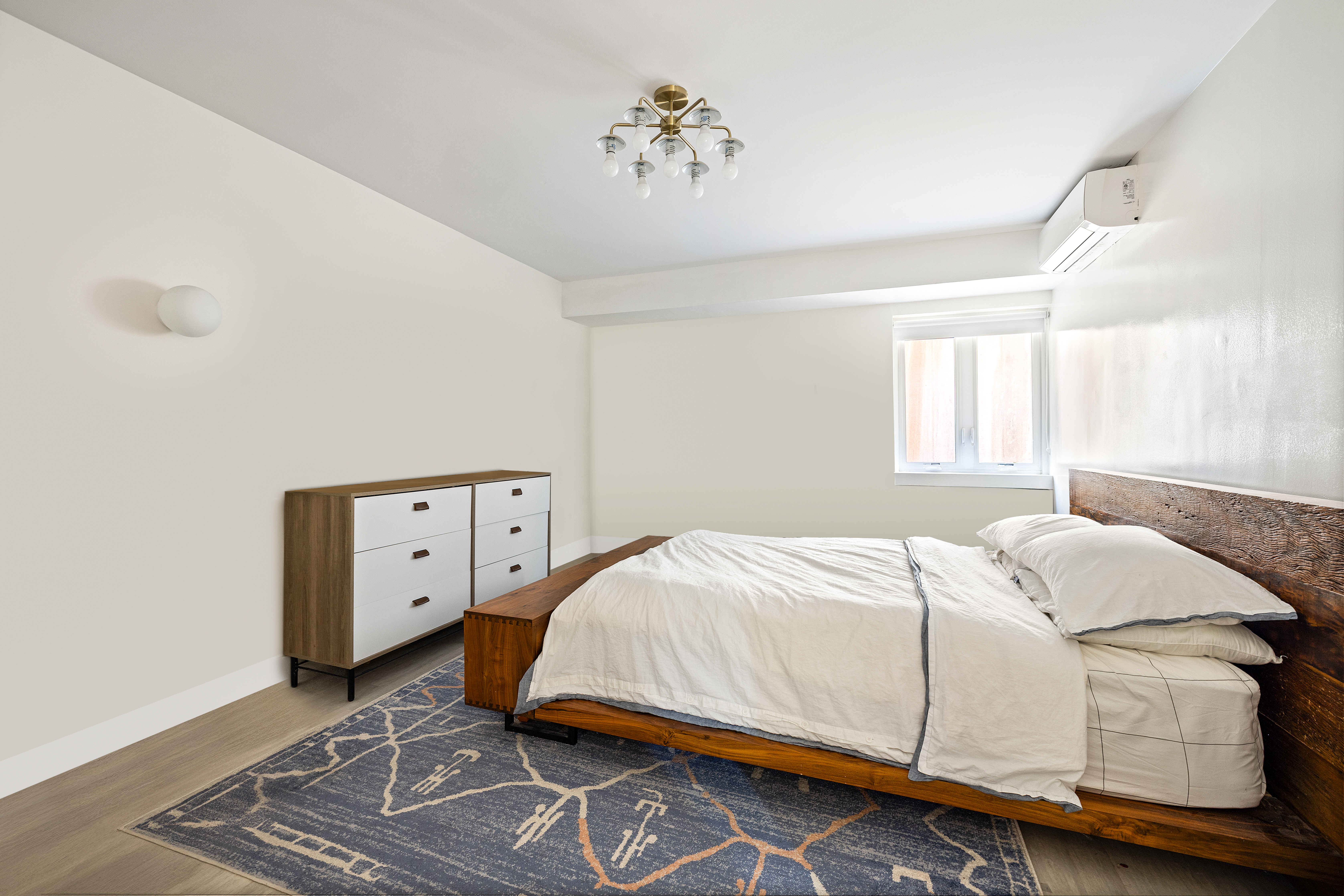 1115-1139 Prospect Avenue, Unit 1B Brooklyn, NY 11218 - Photo 6 of 9 a bedroom with a bed and window