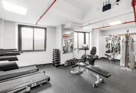 a room with gym equipment and a large window