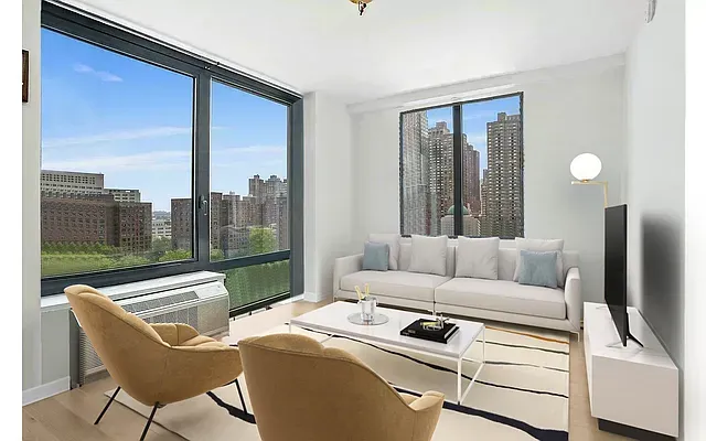 a living room with furniture and a floor to ceiling window