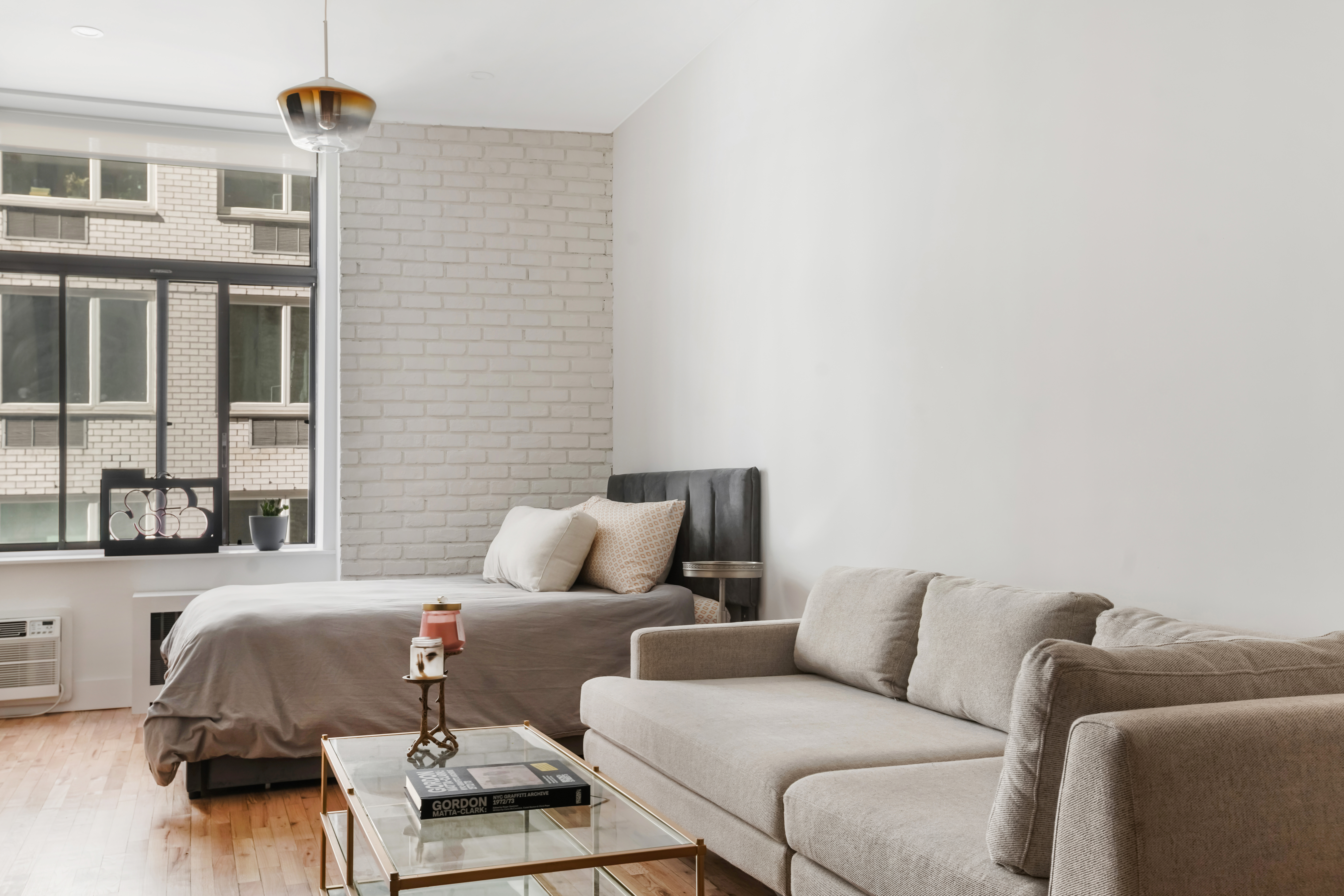 310 East 23rd Street, Unit 3B Manhattan, NY 10010 - Photo 3 of 11 a bedroom with a bed and a couch
