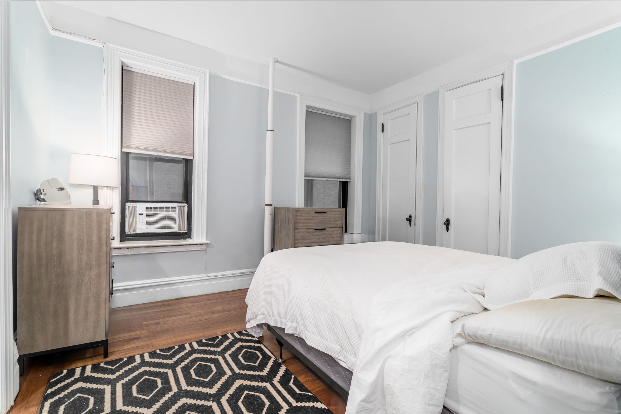 61 East 86th Street, Unit 25 Manhattan, NY 10028 - Photo 4 of 9 a bedroom with a bed and a window
