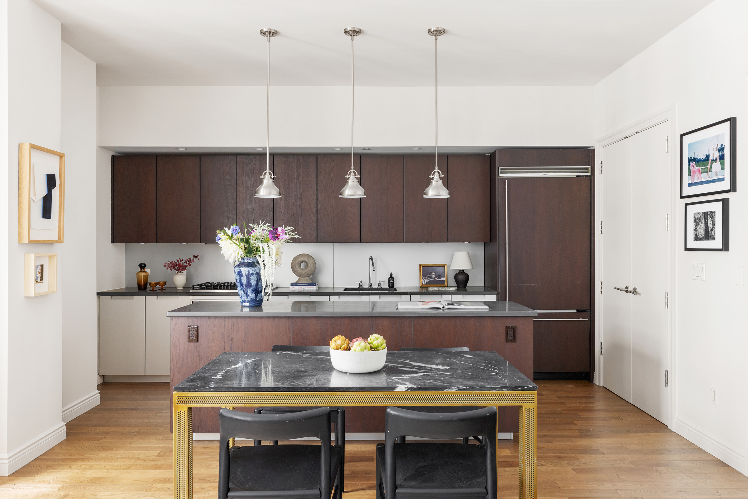 225 5th Avenue, Unit 6T Manhattan, NY 10010 - Photo 4 of 12 a kitchen with granite countertop a table chairs stove and cabinets