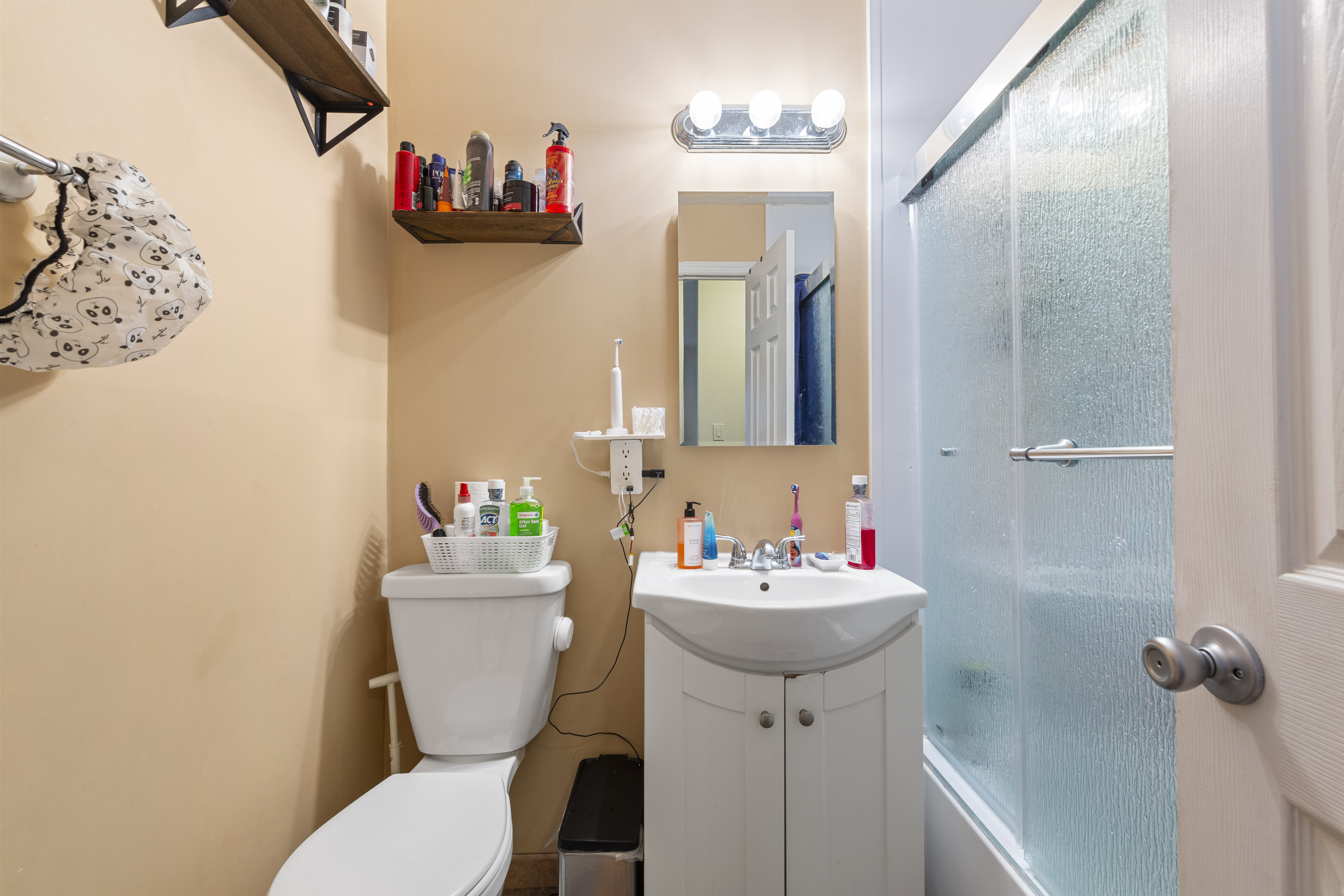240-47 68th Avenue Queens, NY 11362 - Photo 32 of 39 a bathroom with a sink mirror and toilet