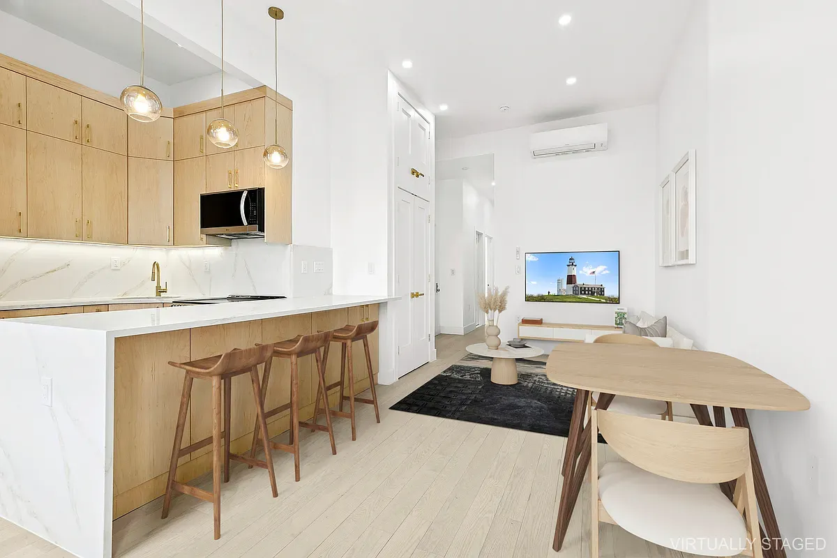 a kitchen with stainless steel appliances kitchen island granite countertop a sink and a stove