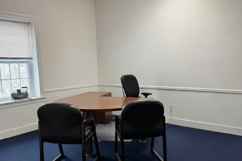 a view of a dining room with furniture and window
