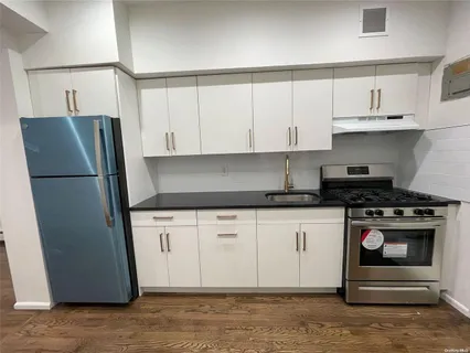 a kitchen with stainless steel appliances granite countertop a refrigerator sink and cabinets