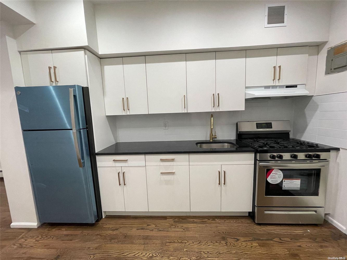 2049 2nd Avenue Manhattan, NY 10029 - Photo 8 of 18 a kitchen with stainless steel appliances granite countertop a refrigerator sink and cabinets