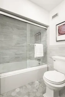 a bathroom with a toilet a sink and bathtub