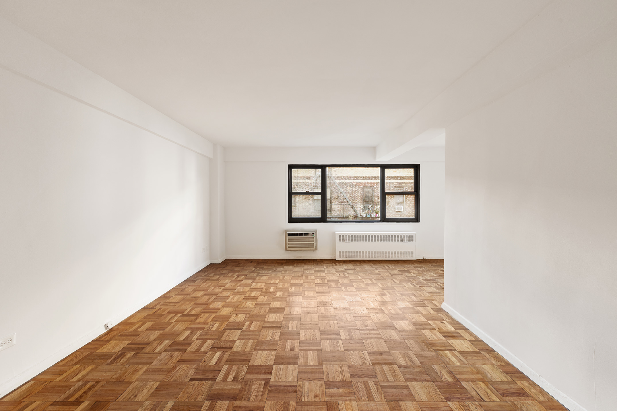 335 East 51st Street, Unit 6G Manhattan, NY 10022 - Photo 2 of 12 a view of an empty room with a window