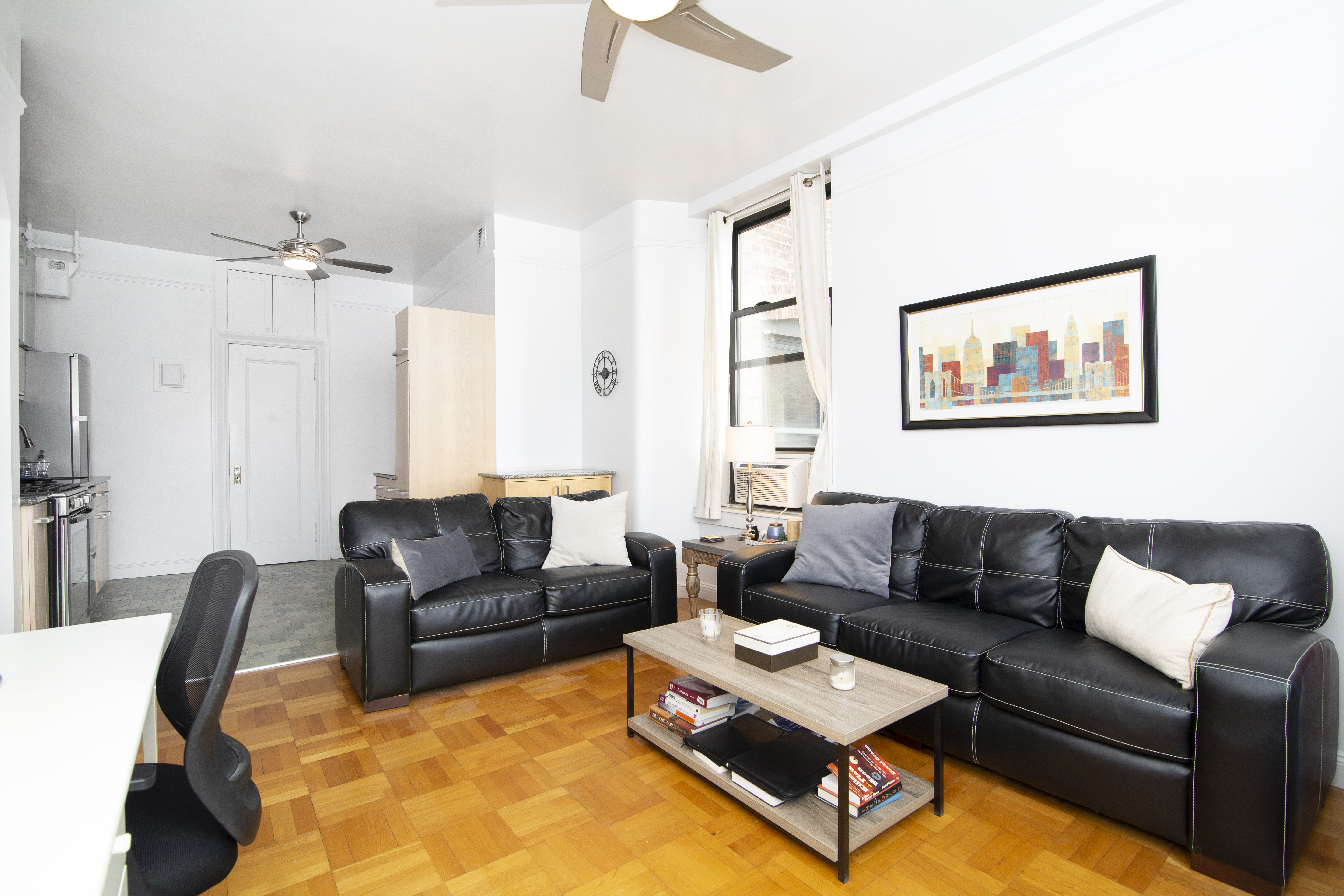 504 West 110th Street, Unit 8F Manhattan, NY 10025 - Photo 5 of 7 a living room with furniture a rug and a chandelier