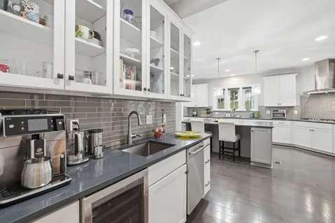 a kitchen with cabinets a sink and appliances
