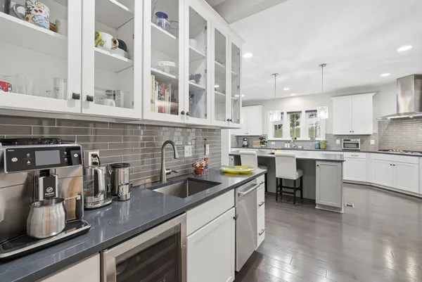 a kitchen with cabinets a sink and appliances