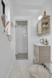 a bathroom with a sink a toilet and shower