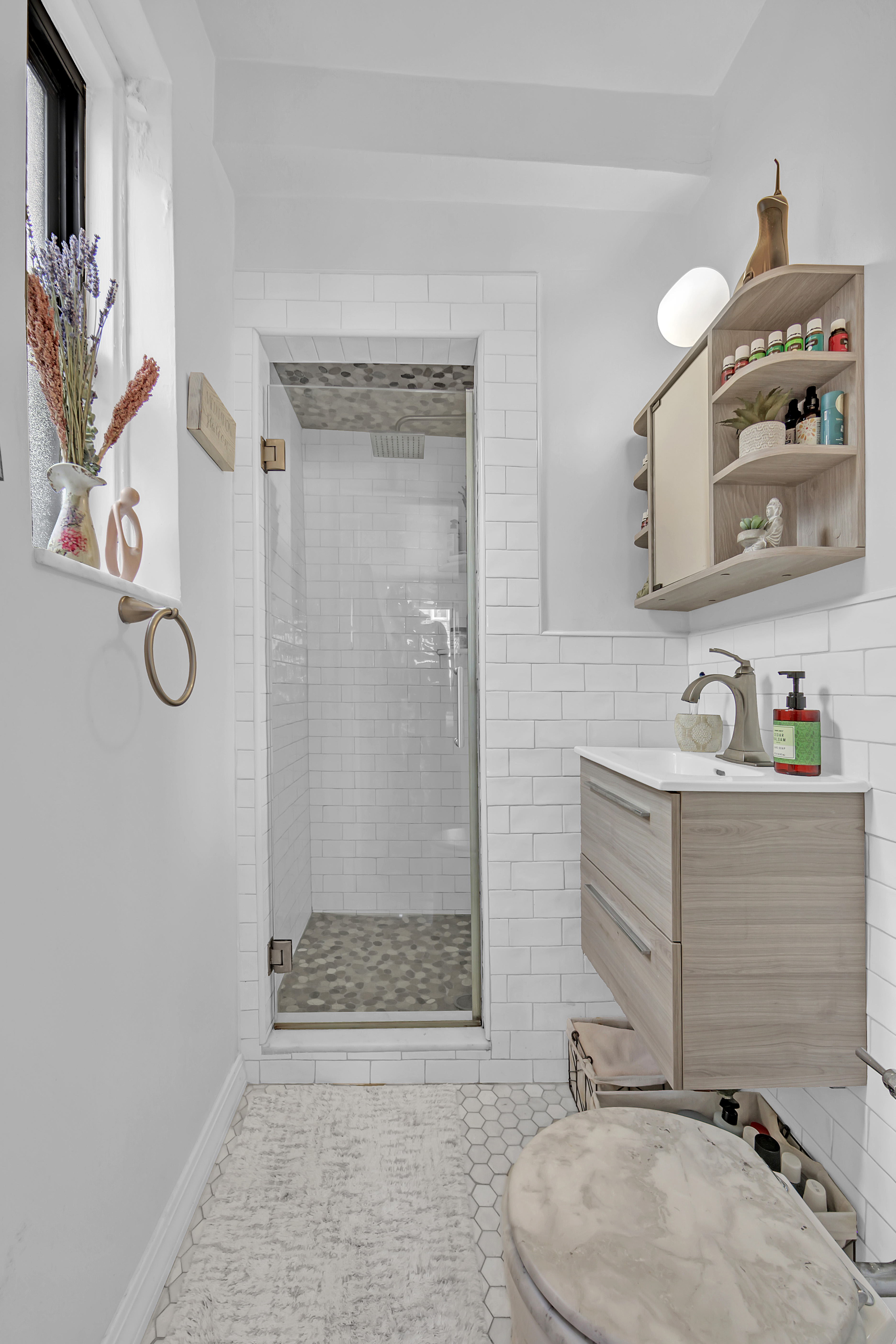 55 East 190th Street, Unit 59 Bronx, NY 10468 - Photo 7 of 14 a bathroom with a sink a toilet and shower