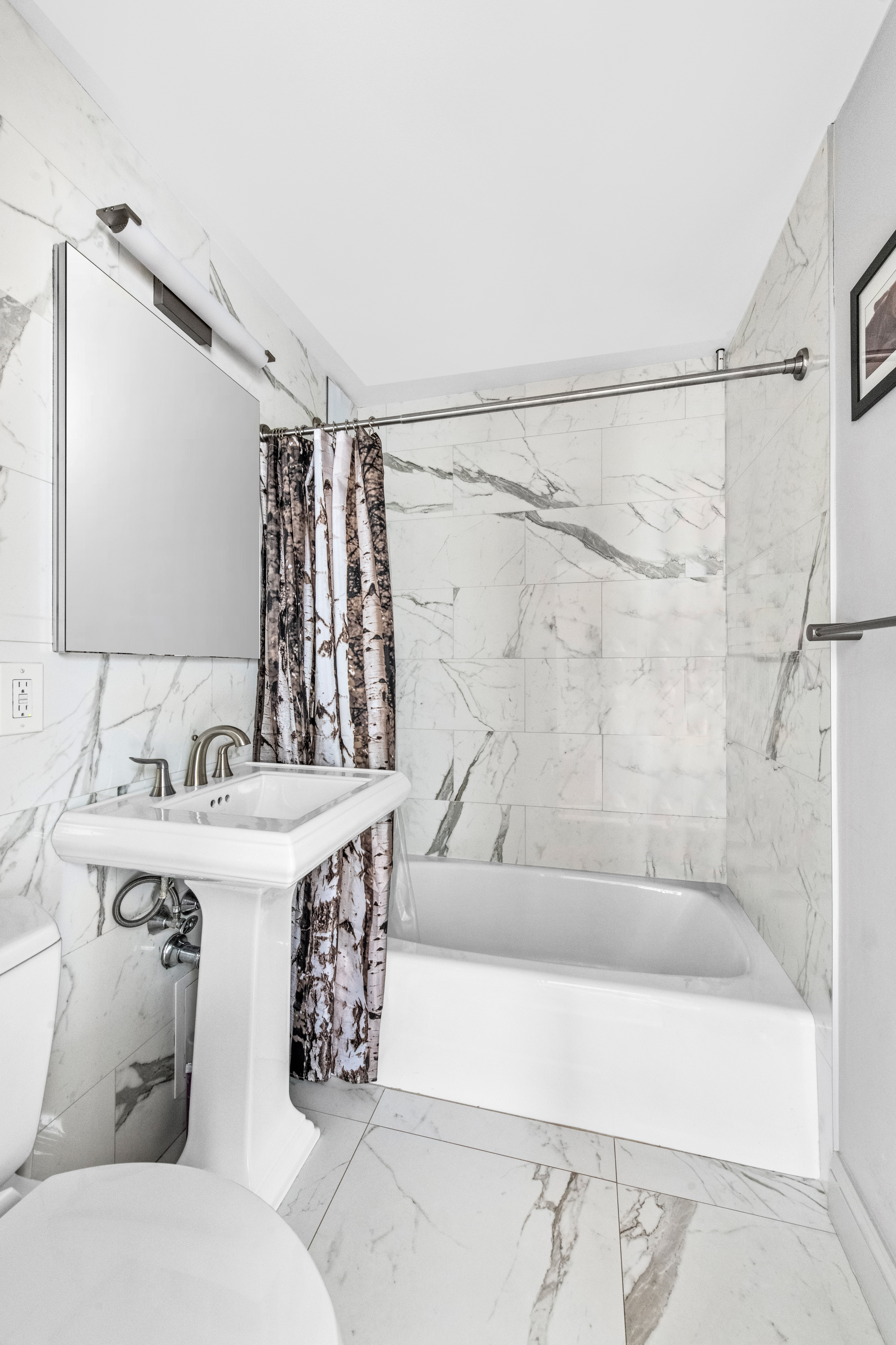 180 West End Avenue, Unit 25M Manhattan, NY 10023 - Photo 8 of 11 a bathroom with a bathtub and a sink