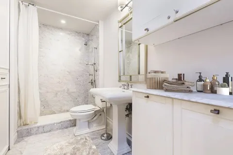 a bathroom with a sink toilet and shower